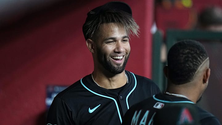 Arizona Diamondbacks outfielder Lourdes Gurriel Jr. (12) smiles in the dugout with his teammates before they play against the Cleveland Guardians at Chase Field on Aug. 19, 2025.