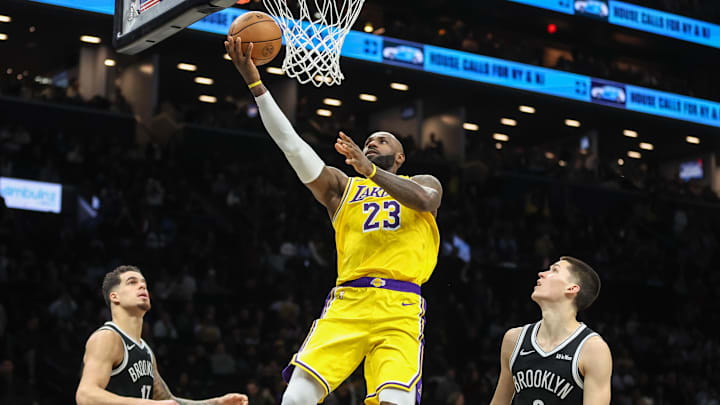 Feb 3, 2026; Brooklyn, New York, USA;  Los Angeles Lakers forward LeBron James (23) drives past Brooklyn Nets guard Egor Demin (8) in the third quarter at Barclays Center. Mandatory Credit: Wendell Cruz-Imagn Images