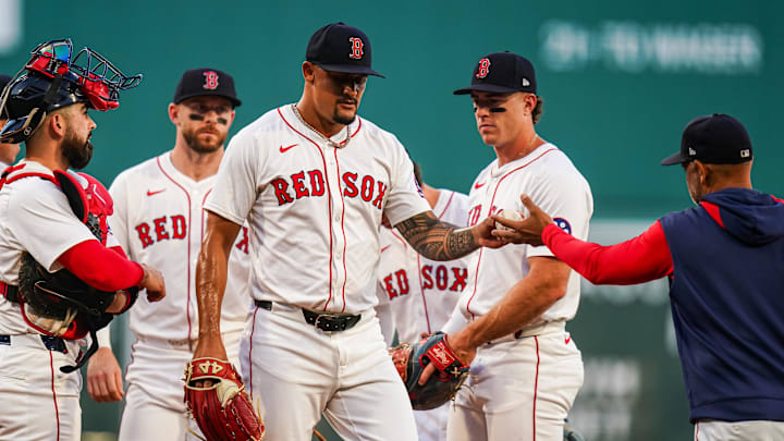 Sep 3, 2025; Boston, Massachusetts, USA; Boston Red Sox pitcher Brennan Bernardino (83) is relieved by manager Alex Cora (13) against the Cleveland Guardians in the first inning at Fenway Park. Mandatory Credit: David Butler II-Imagn Images
