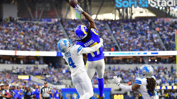 Dec 14, 2025; Inglewood, California, USA; Los Angeles Rams wide receiver Davante Adams (17) goes up for a pass against Detroit Lions cornerback D.J. Reed (4) during the second quarter at SoFi Stadium. Mandatory Credit: Gary A. Vasquez-Imagn Images