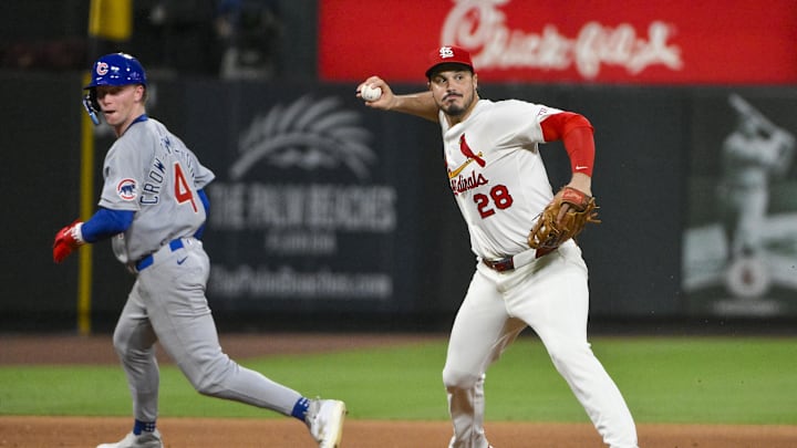 Jun 24, 2025; St. Louis, Missouri, USA;  St. Louis Cardinals third baseman Nolan Arenado (28) barehands a ground ball and throws out Chicago Cubs shortstop Dansby Swanson (not pictured) during the ninth inning at Busch Stadium. Mandatory Credit: Jeff Curry-Imagn Images