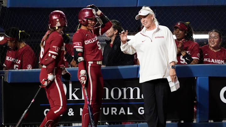Oklahoma coach Patty Gasso talks Ailana Agbayani, center, and Abigale Dayton during a college Bedlam softball game between the University of Oklahoma Sooners (OU) and the Oklahoma State University Cowgirls (OSU) at Devon Park in Oklahoma City, Wednesday, April 9, 2025.