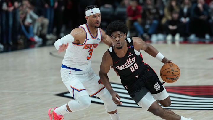 Mar 12, 2025; Portland, Oregon, USA; Portland Trail Blazers guard Scoot Henderson (00) dribbles the ball against New York Knicks shooting guard Josh Hart (3) during overtime at Moda Center. Mandatory Credit: Soobum Im-Imagn Images
