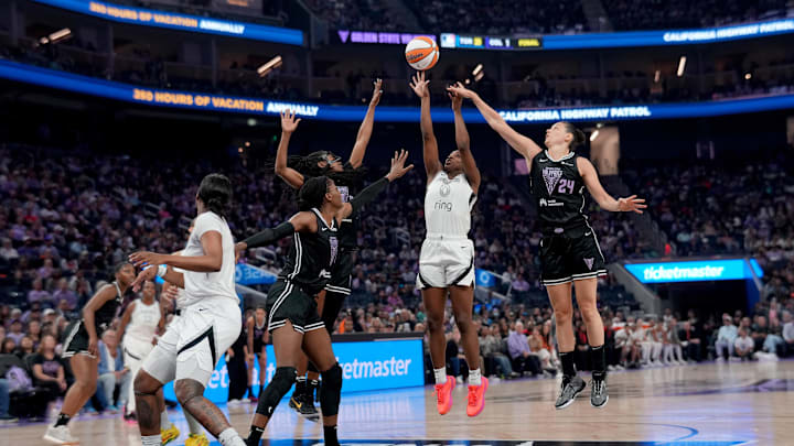 Aug 6, 2025; San Francisco, California, USA; Las Vegas Aces guard Jackie Young (0) shoots the ball between Golden State Valkyries guard Tiffany Hayes (15) and forward Cecilia Zandalasini (24) in the second quarter at the Chase Center. Aug 6, 2025; San Francisco, California, USA; Las Vegas Aces guard Jackie Young (0) shoots the ball between Golden State Valkyries guard Tiffany Hayes (15) and forward Cecilia Zandalasini (24) in the second quarter at the Chase Center.