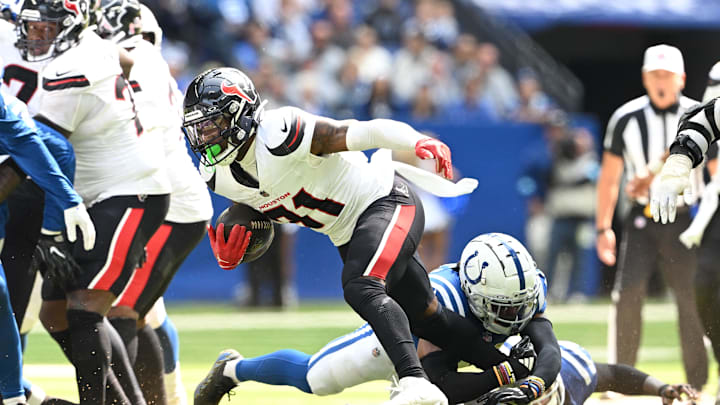 Sep 8, 2024; Indianapolis, Indiana, USA; Houston Texans running back Dameon Pierce (31) is tackled by Indianapolis Colts cornerback Kenny Moore II (23) during the second half at Lucas Oil Stadium. Mandatory Credit: Marc Lebryk-Imagn Images