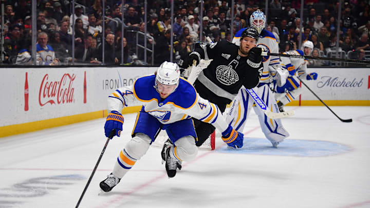 Mar 21, 2026; Los Angeles, California, USA; Buffalo Sabres defenseman Bowen Byram (4) moves the puck against Los Angeles Kings right wing Joel Armia (40) during the second period at Crypto.com Arena. Mandatory Credit: Gary A. Vasquez-Imagn Images