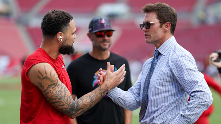 Fox NFL broadcaster and former NFL quarterback Tom Brady speaks to Tampa Bay Buccaneers wide receiver Mike Evans.