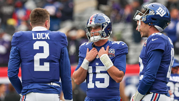 Dec 15, 2024; East Rutherford, New Jersey, USA; New York Giants quarterback Tommy DeVito (15) talks with quarterback Drew Lock (2) and quarterback Drew Lock (2) before the game against the Baltimore Ravens at MetLife Stadium.  