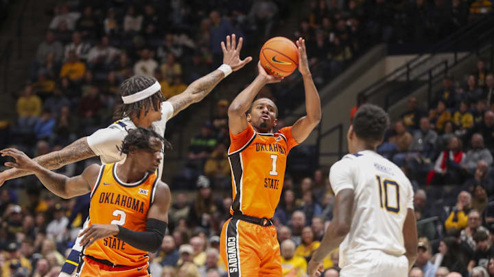 Jan 4, 2025; Morgantown, West Virginia, USA; Oklahoma State Cowboys guard Bryce Thompson (1) shoots a three-point shot during the second half against the West Virginia Mountaineers at WVU Coliseum. Mandatory Credit: Ben Queen-Imagn Images Jan 4, 2025; Morgantown, West Virginia, USA; Oklahoma State Cowboys guard Bryce Thompson (1) shoots a three-point shot during the second half against the West Virginia Mountaineers at WVU Coliseum. Mandatory Credit: Ben Queen-Imagn Images
