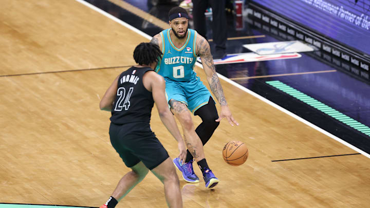 Mar 9, 2024; Charlotte, North Carolina, USA;  Charlotte Hornets forward Miles Bridges (0) sets the play against Brooklyn Nets guard Cam Thomas (24) during the fourth quarter at Spectrum Center. Mandatory Credit: Cory Knowlton-USA TODAY Sports