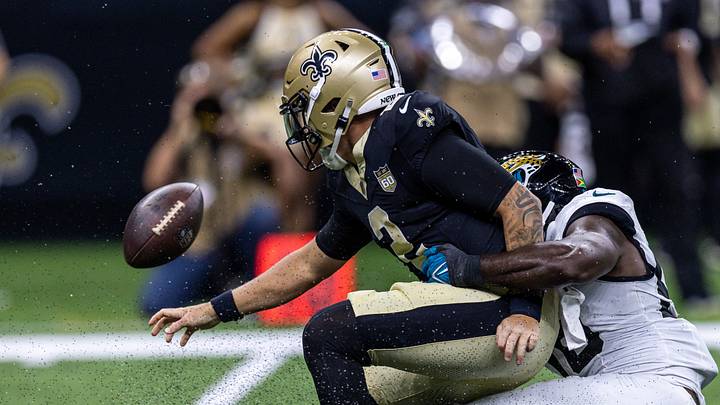 Aug 15, 2026; New Orleans, Louisiana, USA;  New Orleans Saints quarterback Spencer Rattler (2) scrambles from the pocket and fumbles the ball against Jacksonville Jaguars linebacker Yasir Abdullah (56) during the first half at Caesars Superdome. Mandatory Credit: Stephen Lew-Imagn Images