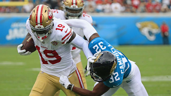 Jacksonville Jaguars cornerback Tyson Campbell (32) tackles San Francisco 49ers wide receiver Deebo Samuel (19)