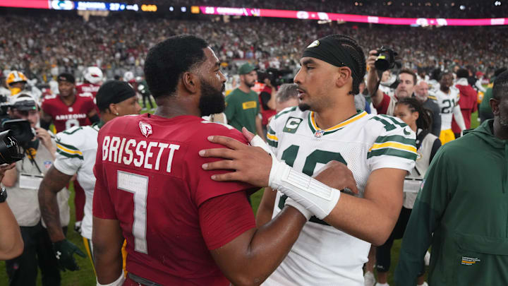 Arizona Cardinals quarterback Jacoby Brissett (7) embraces Green Bay Packers quarterback Jordan Love (10) after the Packers' 27-23 win over the Cardinals at State Farm Stadium in Glendale on Oct. 19, 2025.
