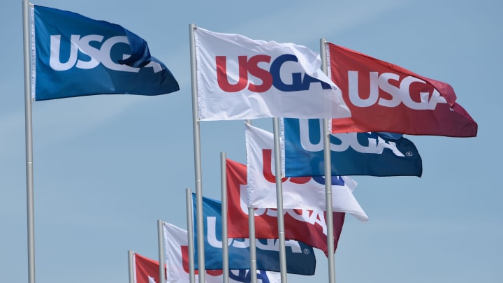 A general view of USGA flags on top of the 18th grandstand during practice rounds of the U.S. Open