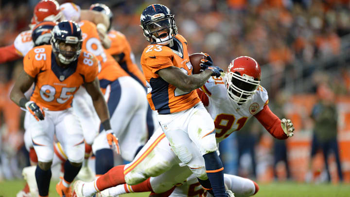 Nov 15, 2015; Denver, CO, USA; Denver Broncos running back Ronnie Hillman (23) avoids a tackle by Kansas City Chiefs outside linebacker Tamba Hali (91) in the third quarter at Sports Authority Field at Mile High. Mandatory Credit: Ron Chenoy-Imagn Images