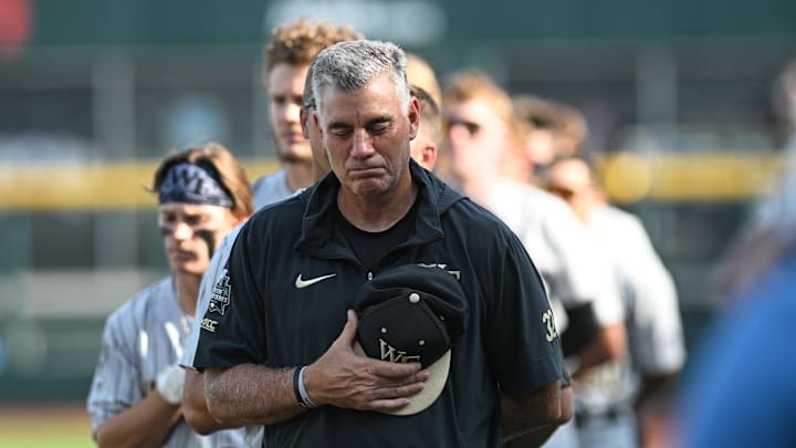 Jun 22, 2023; Omaha, NE, USA;  Wake Forest Demon Deacons head coach Tom Walter stands with the team during the national anthem before the game against the LSU Tigers at Charles Schwab Field Omaha. Mandatory Credit: Steven Branscombe-Imagn Images