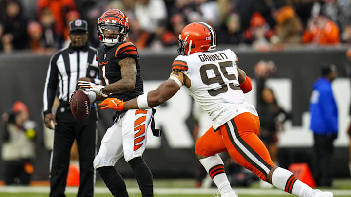 Cincinnati Bengals wide receiver Ja'Marr Chase (1) drops back to throw a pass on a trick play before being tackled by Cleveland Browns defensive end Myles Garrett. Cincinnati Bengals wide receiver Ja'Marr Chase (1) drops back to throw a pass on a trick play before being tackled by Cleveland Browns defensive end Myles Garrett.