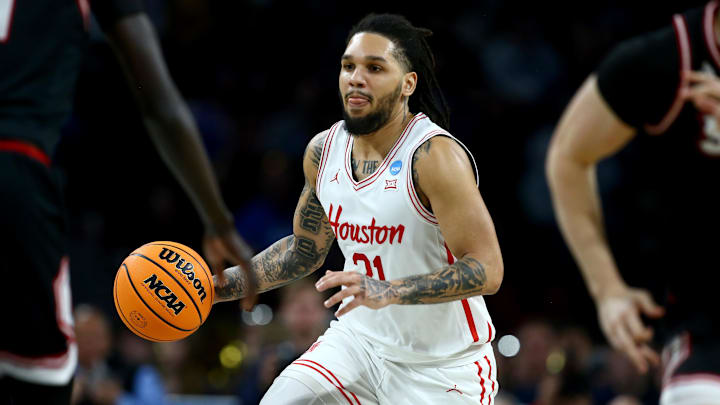 Mar 20, 2025; Wichita, KS, USA; Houston Cougars guard Emanuel Sharp (21) dribbles in the second half of a first round men’s NCAA Tournament game against the SIU Edwardsville Cougars at Intrust Bank Arena. Mandatory Credit: Nick Tre. Smith-Imagn Images