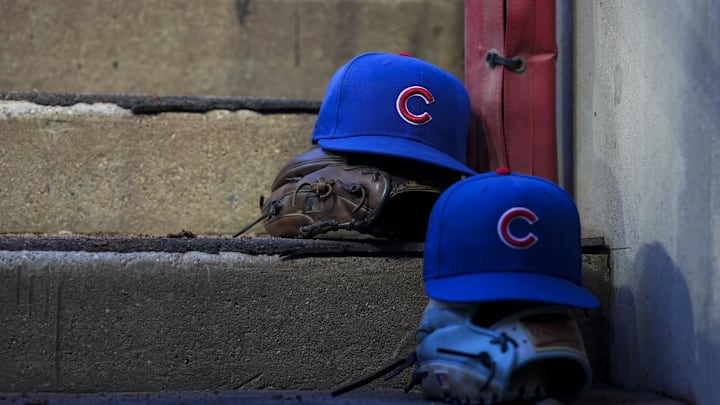 Sep 20, 2025; Cincinnati, Ohio, USA; Chicago player hats are seen on the dugout steps during the game between the Chicago Cubs and the Cincinnati Reds at Great American Ball Park. Mandatory Credit: Aaron Doster-Imagn Images