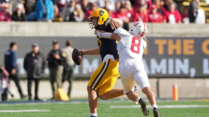 Nov 23, 2024; Berkeley, California, USA; Stanford Cardinal linebacker Tristan Sinclair (8) sacks California Golden Bears quarterback Fernando Mendoza (left) during the second quarter at California Memorial Stadium. Mandatory Credit: Darren Yamashita-Imagn Images