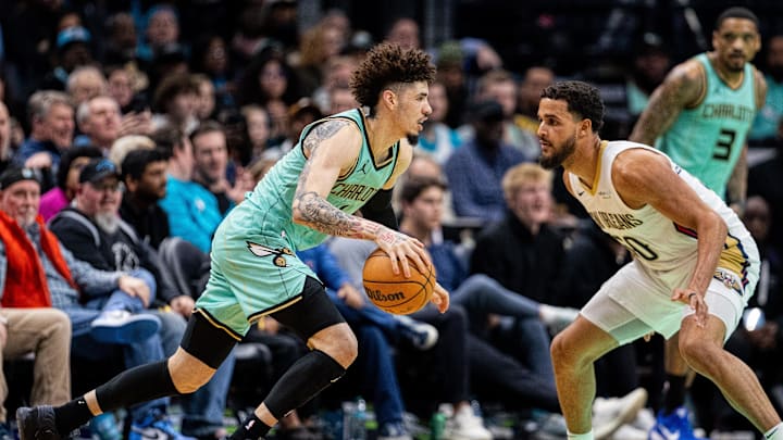 Jan 25, 2025; Charlotte, North Carolina, USA; Charlotte Hornets guard LaMelo Ball (1) drives against New Orleans Pelicans forward Jeremiah Robinson-Earl (50) during the fourth quarter at Spectrum Center. Mandatory Credit: Scott Kinser-Imagn Images