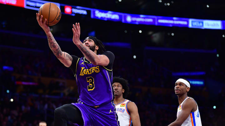 Mar 24, 2023; Los Angeles, California, USA; Los Angeles Lakers forward Anthony Davis (3) moves to the basket ahead of Oklahoma City Thunder guard Shai Gilgeous-Alexander (2) during the second half at Crypto.com Arena. Mandatory Credit: Gary A. Vasquez-USA TODAY Sports