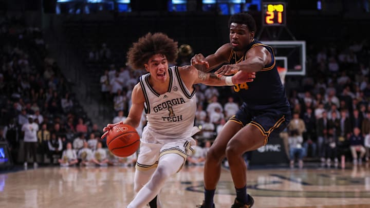 Feb 15, 2025; Atlanta, Georgia, USA; Georgia Tech Yellow Jackets guard Naithan George (1) drives on California Golden Bears forward Lee Dort (34) in the second half at McCamish Pavilion. Mandatory Credit: Brett Davis-Imagn Images