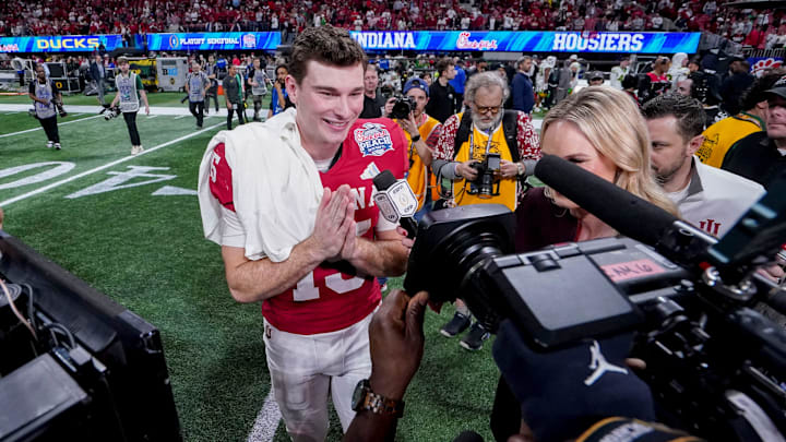 Indiana Hoosiers quarterback Fernando Mendoza (15) is interviewed on the field after defeating the Oregon Ducks in the Peach Bowl and semifinal game of the College Football Playoff at Mercedes-Benz Stadium in Atlanta.