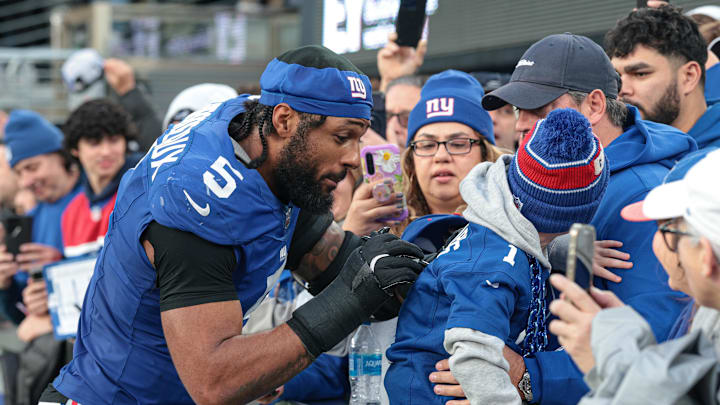 New York Giants linebacker Kayvon Thibodeaux (5) signs an autograph after the game against the Indianapolis Colts at MetLife Stadium. 