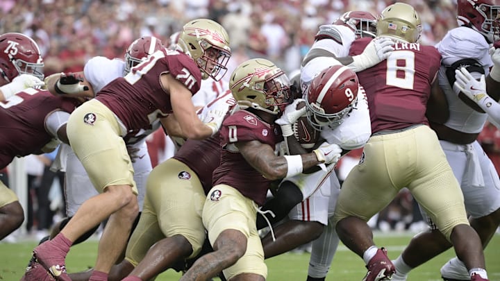 Aug 30, 2025; Tallahassee, Florida, USA; Alabama Crimson Tide running back Richard Young (9) runs with the ball against Florida State Seminoles defensive back Earl Little Jr. (0) during the first half at Doak S. Campbell Stadium. Mandatory Credit: Melina Myers-Imagn Images