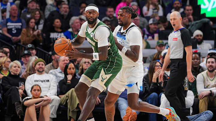 Feb 12, 2025; Minneapolis, Minnesota, USA; Milwaukee Bucks forward Bobby Portis (9) dribbles against the Minnesota Timberwolves center Naz Reid (11) in the second quarter at Target Center. Mandatory Credit: Brad Rempel-Imagn Images