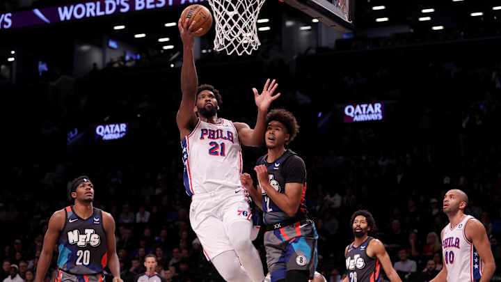 Nov 19, 2023; Brooklyn, New York, USA; Philadelphia 76ers center Joel Embiid (21) drives to the basket against Brooklyn Nets forward Cameron Johnson (2) during the first quarter at Barclays Center. Mandatory Credit: Brad Penner-Imagn Images