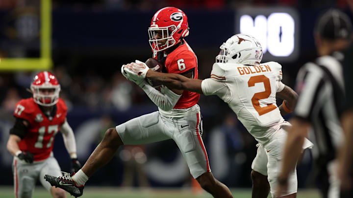 Dec 7, 2024; Atlanta, GA, USA; Georgia Bulldogs wide receiver Dominic Lovett (6) makes a catch against Texas Longhorns defensive back Derek Williams Jr. (2) during the second half in the 2024 SEC Championship game at Mercedes-Benz Stadium. Mandatory Credit: Brett Davis-Imagn Images