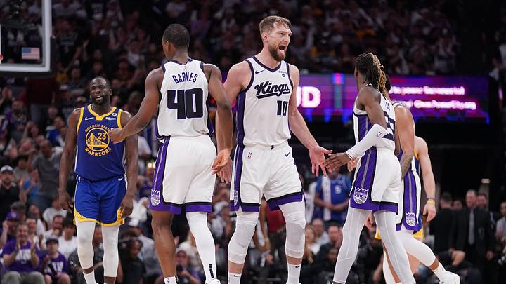 Apr 16, 2024; Sacramento, California, USA; Sacramento Kings forward Domantas Sabonis (10) reacts next to forward Harrison Barnes (40) and guard Keon Ellis (23) after the Kings made a basket against the Golden State Warriors in the fourth quarter during a play-in game of the 2024 NBA playoffs at the Golden 1 Center. Mandatory Credit: Cary Edmondson-Imagn Images
