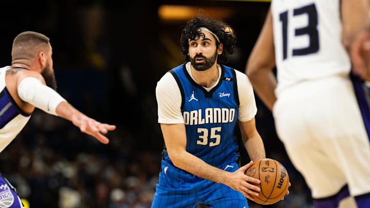 Mar 29, 2025; Orlando, Florida, USA; Orlando Magic center Goga Bitadze (35) looks for the pass against Sacramento Kings center Jonas Valančiūnas (17) in the fourth quarter at Kia Center. Mandatory Credit: Jeremy Reper-Imagn Images