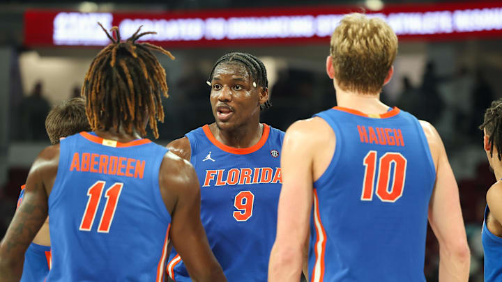Feb 11, 2025; Starkville, Mississippi, USA; Florida Gators center Rueben Chinyelu (9) talks to guard Denzel Aberdeen (11) and forward Thomas Haugh (10) during the second half against the Mississippi State Bulldogs at Humphrey Coliseum. Mandatory Credit: Wesley Hale-Imagn Images