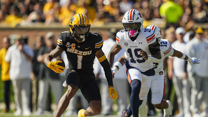 Oct 19, 2024; Columbia, Missouri, USA; Missouri Tigers wide receiver Theo Wease Jr. (1) runs with the ball against Auburn Tigers safety Sylvester Smith (19) during the first half at Faurot Field at Memorial Stadium. Mandatory Credit: Jay Biggerstaff-Imagn Images