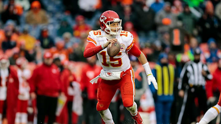 Dec 31, 2017; Denver, CO, USA; Kansas City Chiefs quarterback Patrick Mahomes (15) scrambles in the back field against the Denver Broncos at Sports Authority Field at Mile High. Mandatory Credit: Isaiah J. Downing-Imagn Images