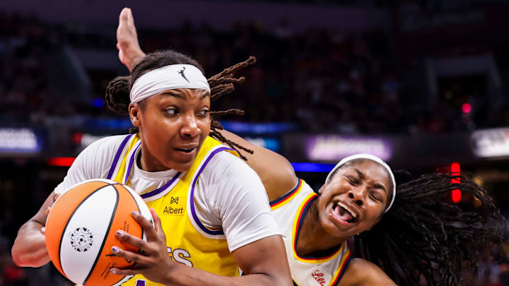 Los Angeles Sparks forward Liatu King (4) grabs the ball while Indiana Fever guard Aari McDonald (2) falls back Thursday, June 26, 2025, during a game between the Indiana Fever and the Los Angeles Sparks at Gainbridge Fieldhouse in Indianapolis.