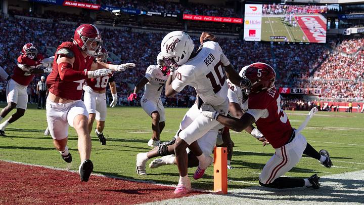 Oct 24, 2026; Tuscaloosa, AL, USA;  Texas A&M quarterback Marcel Reed (10) scores between Alabama linebacker Luke Metz (4) and Alabama Dijon Lee Jr. (5) at Saban Field at Bryant Denny Stadium. Mandatory Credit: Gary Cosby Jr.-Tuscaloosa News