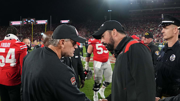 Jan 1, 2022; Pasadena, CA, USA; Utah Utes head coach Kyle Wittingham and Ohio State Buckeyes head coach Ryan Day shake hands on the field after the 2022 Rose Bowl college football game at the Rose Bowl. Mandatory Credit: Kirby Lee-Imagn Images