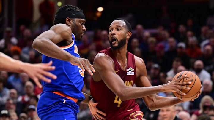 Cleveland Cavaliers forward Evan Mobley drives to the basket against New York Knicks forward Precious Achiuwa during the second half at Rocket Arena. Mandatory Credit: Ken Blaze-Imagn Images