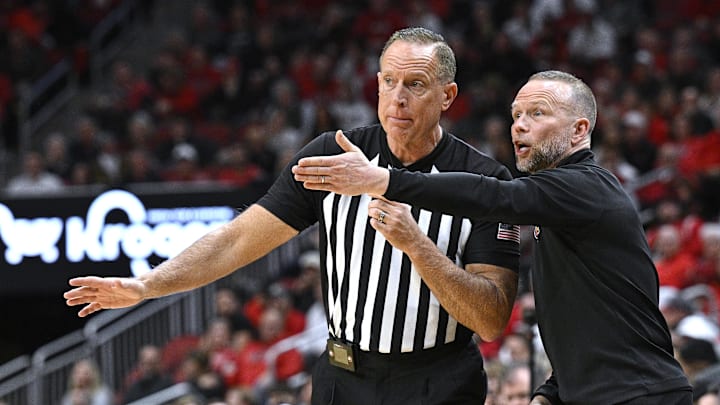 Feb 4, 2026; Louisville, Kentucky, USA;  Louisville Cardinals head coach Pat Kelsey questions official Don Daily about a call during the first half against the Notre Dame Fighting Irish at KFC Yum! Center. Mandatory Credit: Jamie Rhodes-Imagn Images