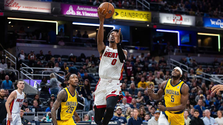 Nov 15, 2024; Indianapolis, Indiana, USA;Miami Heat guard Josh Richardson (0)  shoots the ball while Indiana Pacers guard Quenton Jackson (29) defends in the second half at Gainbridge Fieldhouse. Mandatory Credit: Trevor Ruszkowski-Imagn Images