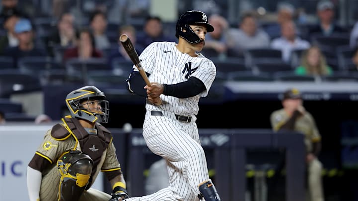 May 7, 2025; Bronx, New York, USA; New York Yankees pinch hitter Trent Grisham (12) follows through on a game tying two run home run against the San Diego Padres during the eighth inning at Yankee Stadium. Mandatory Credit: Brad Penner-Imagn Images
