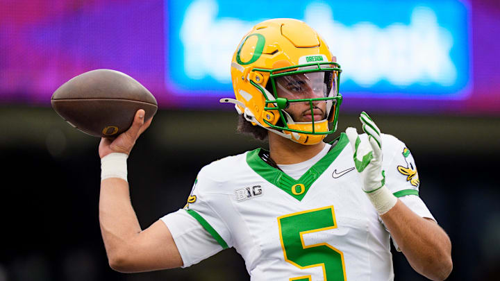 Oregon quarterback Dante Moore warms up as the Oregon Ducks take on the Washington Huskies on Nov. 29, 2025, at Husky Stadium in Seattle, Washington. Oregon quarterback Dante Moore warms up as the Oregon Ducks take on the Washington Huskies on Nov. 29, 2025, at Husky Stadium in Seattle, Washington.