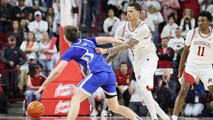 Jan 31, 2026; Fayetteville, Arkansas, USA; Arkansas Razorbacks forward Trevon Brazile (7) fouls Kentucky Wildcats forward Trent Noah (9) during the second half at Bud Walton Arena. Kentucky won 85-77. Mandatory Credit: Nelson Chenault-Imagn Images