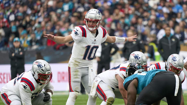 Oct 20, 2024; London, United Kingdom; New England Patriots quarterback Drake Maye (10) signs to players in the first half during an NFL International Series game at Wembley Stadium. Mandatory Credit: Peter van den Berg-Imagn Images