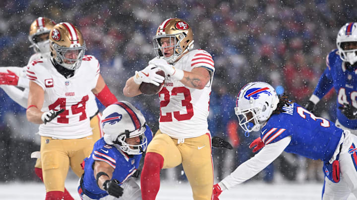 Dec 1, 2024; Orchard Park, New York, USA; San Francisco 49ers running back Christian McCaffrey (23) is tackled by Buffalo Bills safety Taylor Rapp (9) and safety Damar Hamlin (3) in the second quarter at Highmark Stadium. Mandatory Credit: Mark Konezny-Imagn Images
