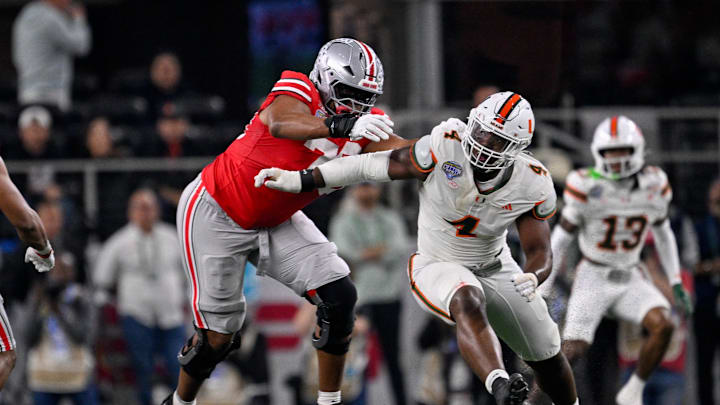 Dec 31, 2025; Arlington, TX, USA; Ohio State Buckeyes offensive lineman Phillip Daniels (70) blocks Miami Hurricanes defensive lineman Rueben Bain Jr. (4) during the 2025 Cotton Bowl and quarterfinal game of the College Football Playoff at AT&T Stadium. Mandatory Credit: Jerome Miron-Imagn Images Dec 31, 2025; Arlington, TX, USA; Ohio State Buckeyes offensive lineman Phillip Daniels (70) blocks Miami Hurricanes defensive lineman Rueben Bain Jr. (4) during the 2025 Cotton Bowl and quarterfinal game of the College Football Playoff at AT&T Stadium. Mandatory Credit: Jerome Miron-Imagn Images